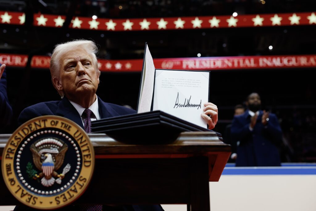 President Donald Trump holds up an executive order after signing it during an indoor inauguration parade at the Capital One Arena on Jan. 20, 2025 in Washington, D.C. (Photo by Anna Moneymaker/Getty Images)