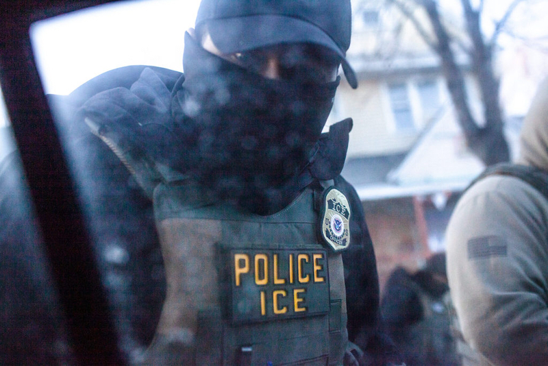 A masked ICE agent knocks on the window of an observer’s vehicle in Minnesota in January. Some Democratic states want to restrict the actions of federal immigration enforcement officers.