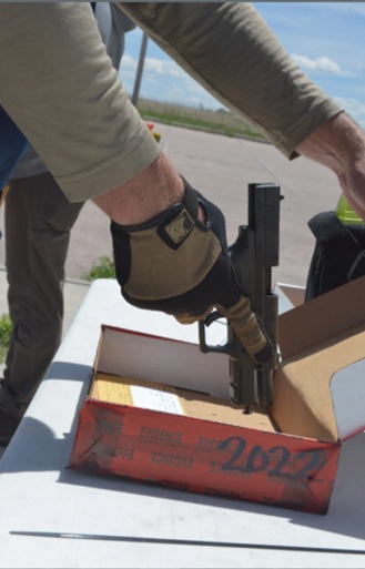 An FBI agent holds a pistol fired as part of a ballistics testing effort on the Pine Ridge Reservation that began on June 15, 2026. (Courtesy of FBI)