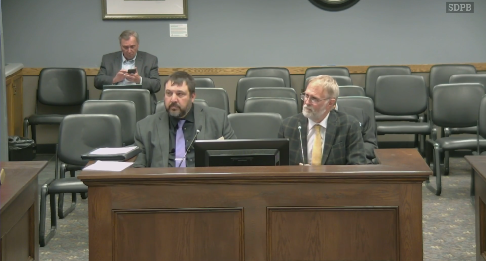 South Dakota Department of Education irector of Finance and Management Cody Stoeser (left) and School Finance Accountability Board Chairman Eric Stroeder (right) present the board's 2025 recommendations to the Interim Joint Appropriations Committee on Dec. 1, 2025. (Courtesy of South Dakota Public Broadcasting)