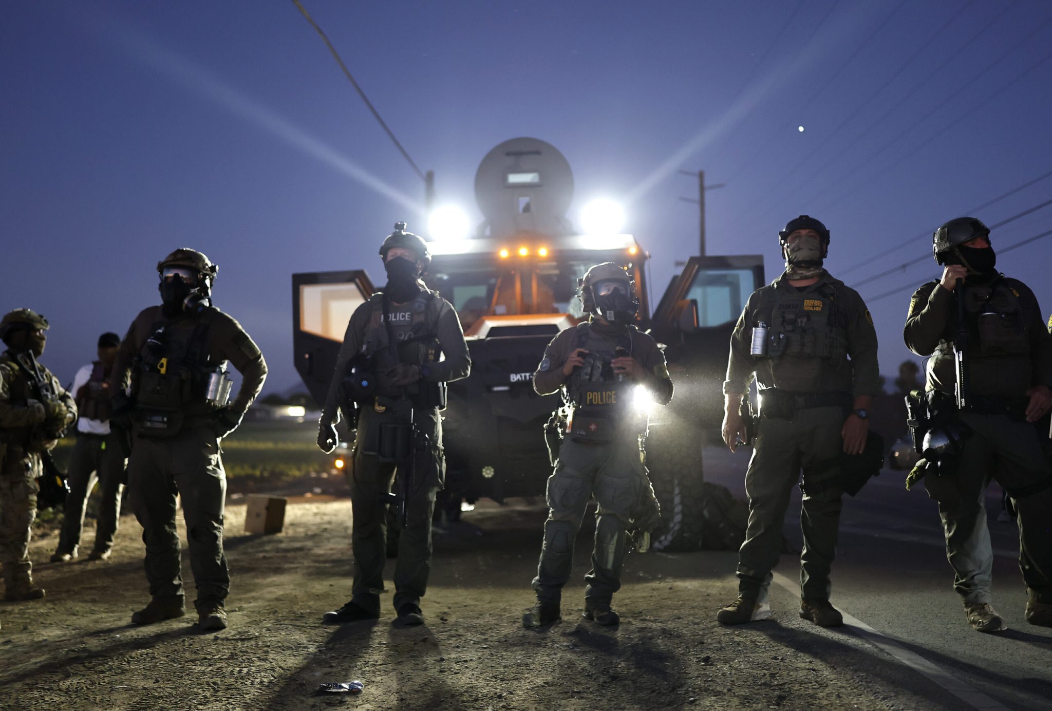 Federal agents block people protesting an ICE immigration raid at a nearby licensed cannabis farm on July 10, 2025 near Camarillo, California. Protestors stood off with federal agents for hours outside the farm in the farmworker community in Ventura County. A Los Angeles federal judge is set to rule Friday on a temporary restraining order which would restrict area immigration enforcement operations. (Photo by Mario Tama/Getty Images)