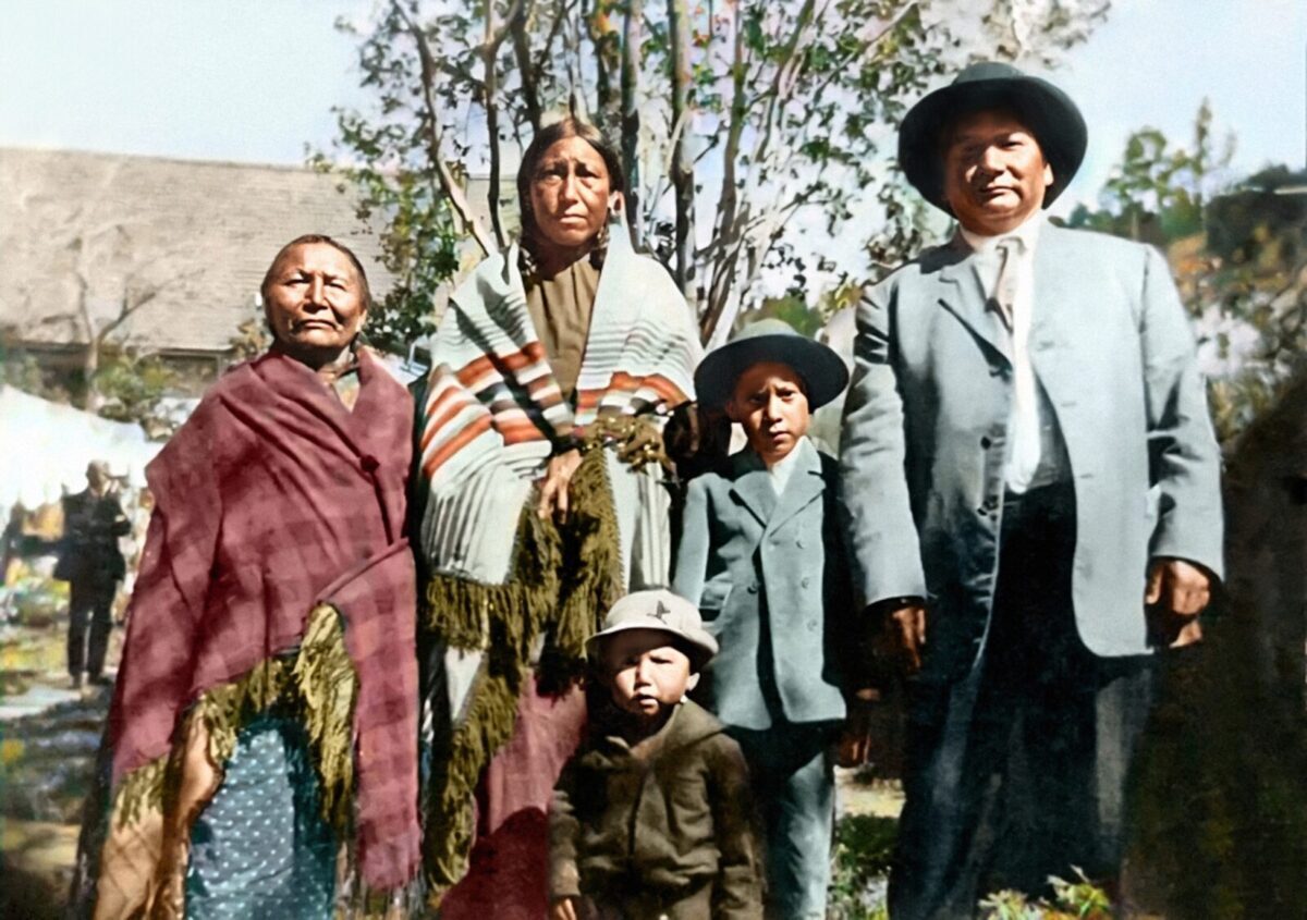 This 1930s image shows Marlis Afraid of Hawk's great-grandmother He Ska Win, aka White Mountain Woman; grandmother Mabel Afraid of Hawk; grandfather Richard Afraid of Hawk; and Mabel and Richard's two sons, Bert and Cain. Richard survived the Wounded Knee Massacre as a child. (Courtesy of Marlis Afraid of Hawk/colorized by Stephan Curran)