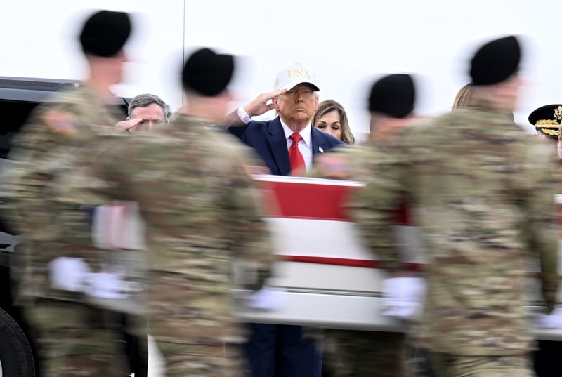 President Donald Trump salutes as a U.S. Army carry team moves a flag-draped transfer case containing the remains of Sgt. Declan J. Coady at Dover Air Force Base on March 07, 2026, in Dover, Delaware. Six soldiers from the 103rd Sustainment Command, including Coady, were killed in action by an Iranian drone strike on March 1 in Port Shuaiba, Kuwait during Operation Epic Fury. (Photo by Roberto Schmidt/Getty Ima