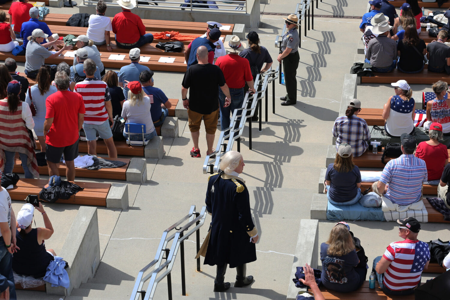 A George Washington impersonator descends a set of stairs in the Mount Rushmore National Memorial amphitheater at South Dakota's Freedom 250 Mount Rushmore Fireworks Celebration on July 3, 2026. (Photo by Meghan O'Brien/South Dakota Searchlight)