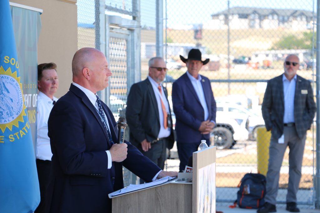Warden Eric Aldridge addresses the crowd at the women's prison ribbon cutting Friday.