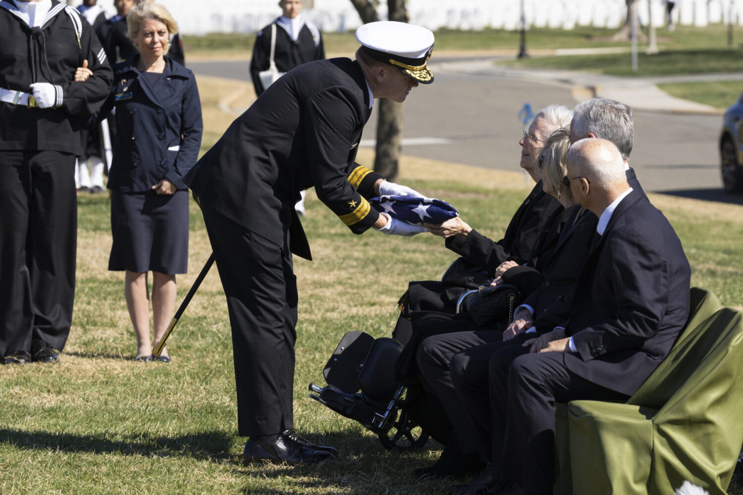 Virginia Connolly accepts a folded flag during a ceremony honoring her father John Connolly at Arlington National Cemetery in March 2025. (Tracey Attlee/Special to the Georgia Recorder)