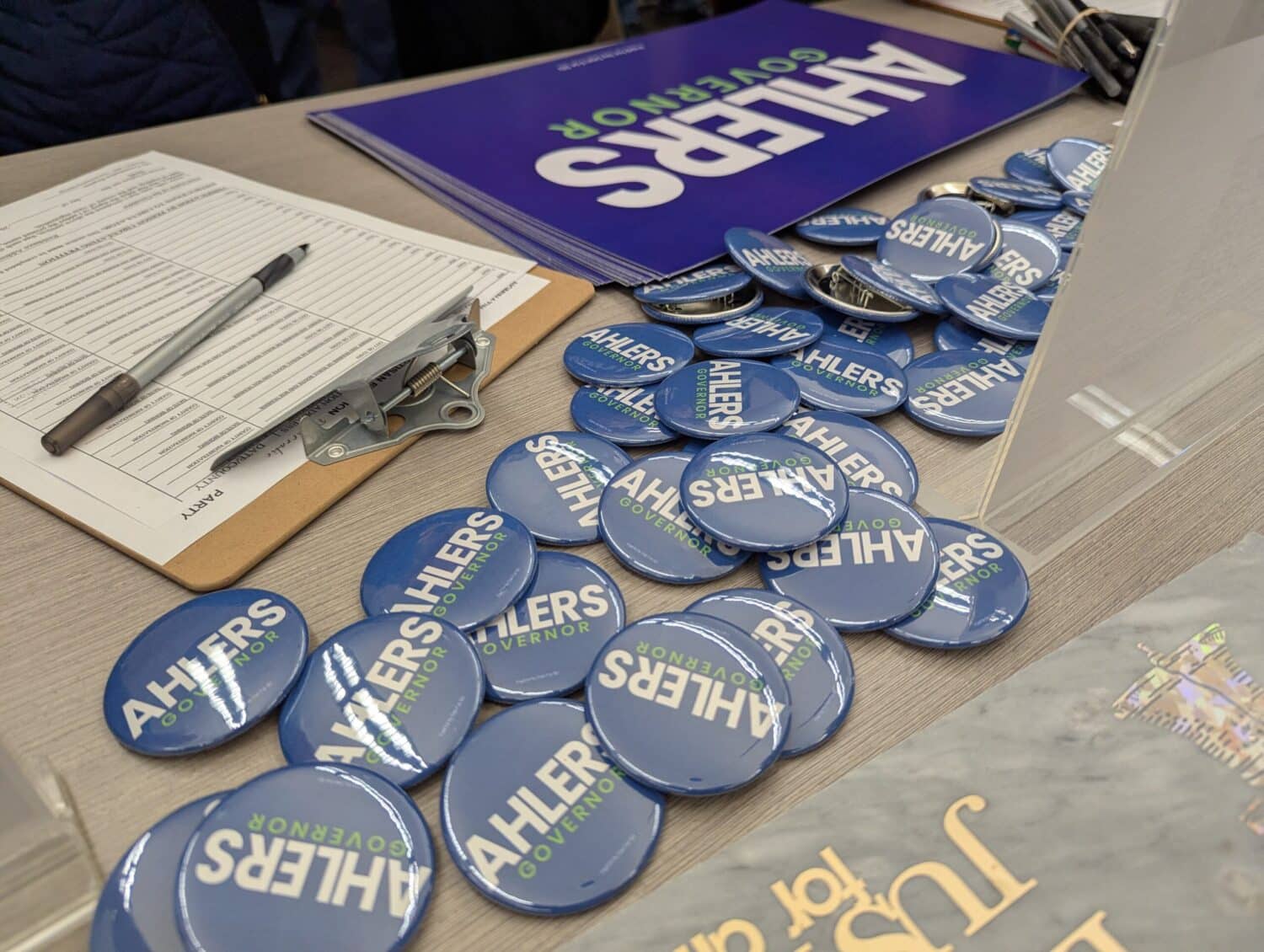 Campaign paraphernalia for Dan Ahlers is laid out on a table on Feb. 10, 2026, at the downtown library in Sioux Falls during the launch of his campaign for the Democratic nomination for governor of South Dakota. (Photo by John Hult/South Dakota Searchlight)