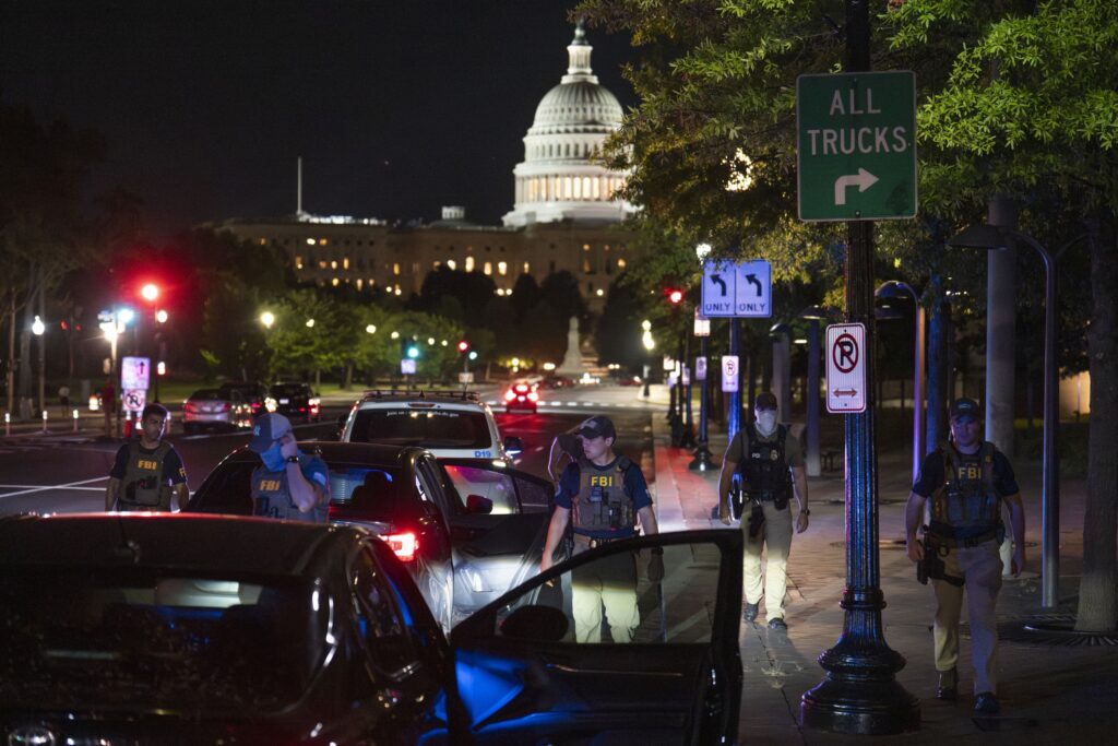 Federal Bureau of Investigation and Metropolitan Police Department officers conduct a traffic stop near the U.S. Capitol on Aug. 14, 2025 in Washington, D.C. (Photo by Kayla Bartkowski/Getty Images)