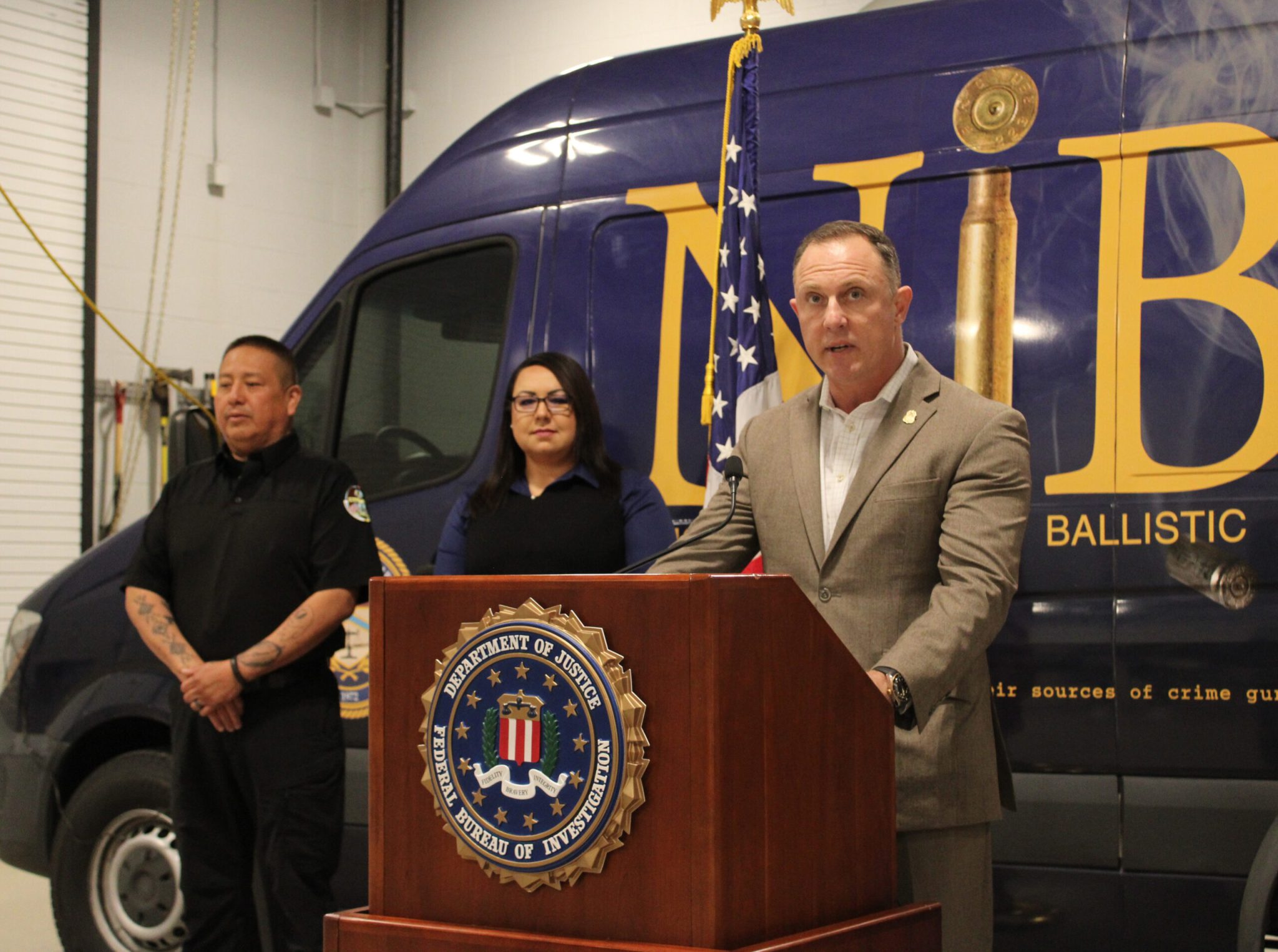 Christopher D. Dotson, Special Agent in Charge, FBI Minneapolis Field Office, speaks on June 16, 2026 in Rapid City, SD. Behind him, from left, are Jason Lone Hill, chief of police, Oglala Sioux Tribe Department of Public Safety, and Jessica D. Four Bear, attorney general for the Oglala Sioux Tribe. (John Hult/South Dakota Searchlight)