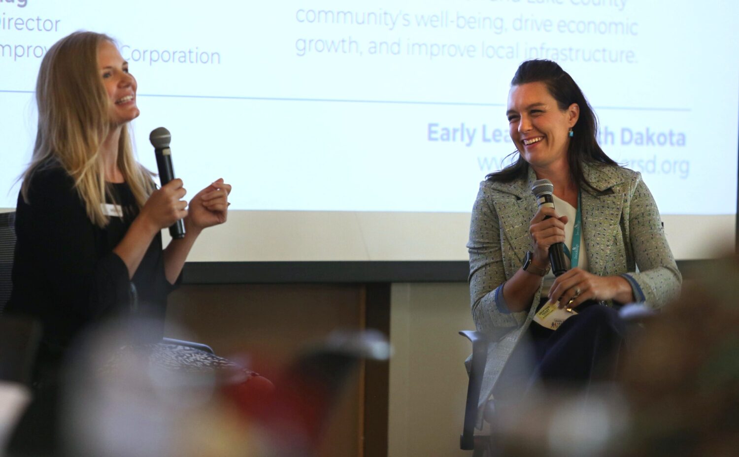 Early Learner South Dakota Executive Director Kayla Klein, left, talks with Lake Area Improvement Corporation Executive Director Brooke Rollag during a session at the Early Learner Summit on Sept. 21, 2023, in Brookings. (Makenzie Huber/South Dakota Searchlight)