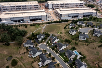STONE RIDGE, VIRGINIA - JULY 17: In an aerial view, an Amazon Web Services data center is shown situated near single-family homes on July 17, 2024 in Stone Ridge, Virginia. Northern Virginia is the largest data center market in the world, according to a report this year cited in published accounts, but is facing headwinds from availability of land and electric power. (Photo by Nathan Howard/Getty Images)
