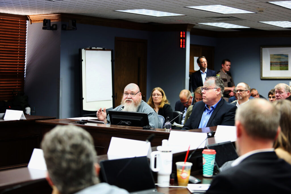 Mike Quinn and Mike Conder of Arrington Watkins consultants in Phoenix, speak to members of the Project Prison Reset work group on June 3, 2025 in Pierre, SD. (Makenzie Huber/South Dakota Searchlight)