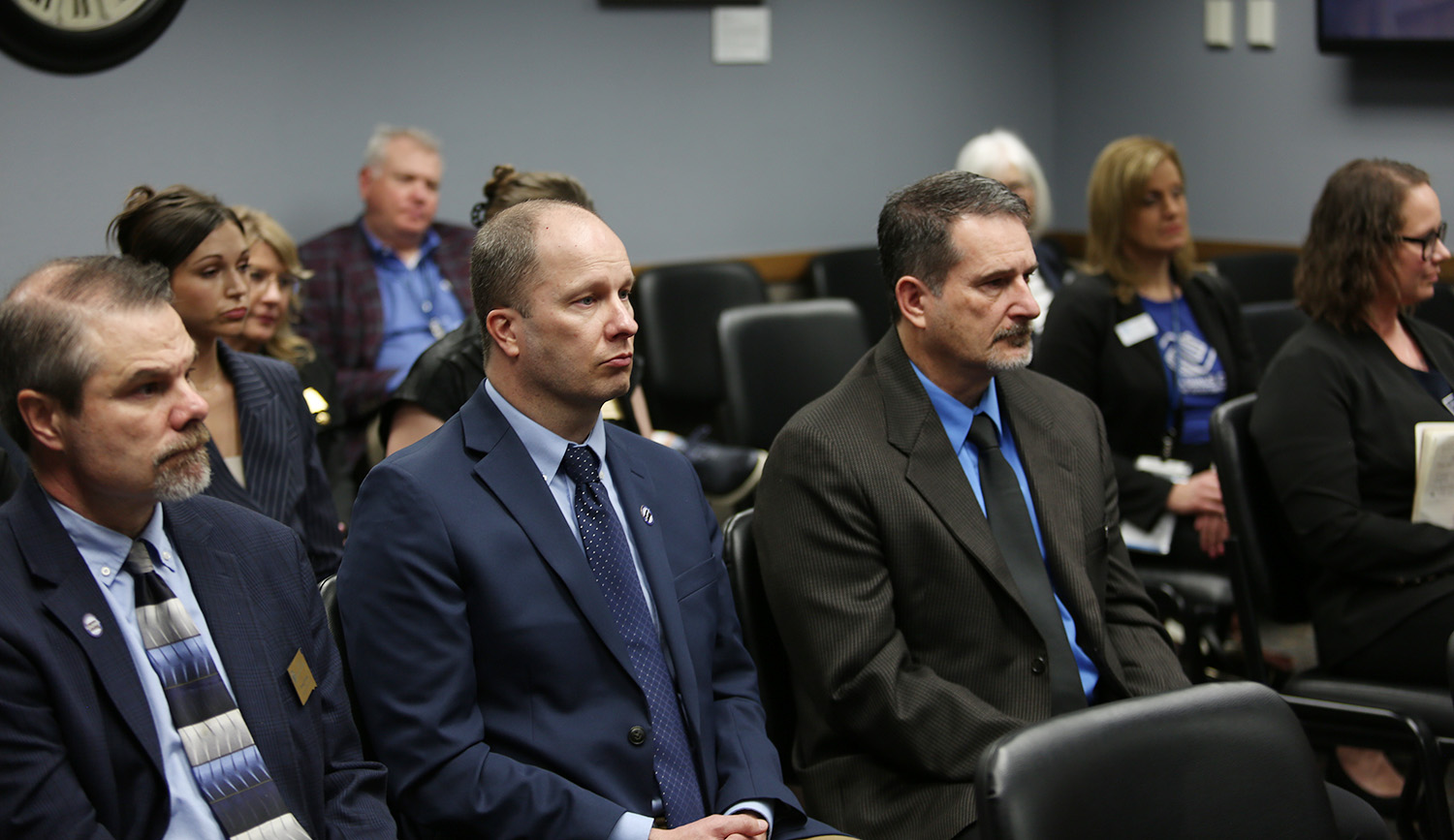 From left, Department of Corrections Deputy Secretary Doug Clark, Human Resources Manager Eric Hildebrandt and Parole Director Brad Lewandowski listen to testimony at the Joint Appropriations Committee on Feb. 21, 2024 in Pierre. (John Hult/South Dakota Searchlight)