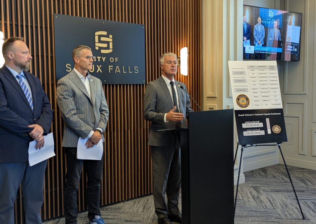 From left, Rapid City Mayor Jason Salamun, Sioux Falls Mayor Paul TenHaken and South Dakota Attorney General Marty Jackley appear at a press conference on Aug. 20, 2025, in Sioux Falls. (John Hult/South Dakota Searchlight)