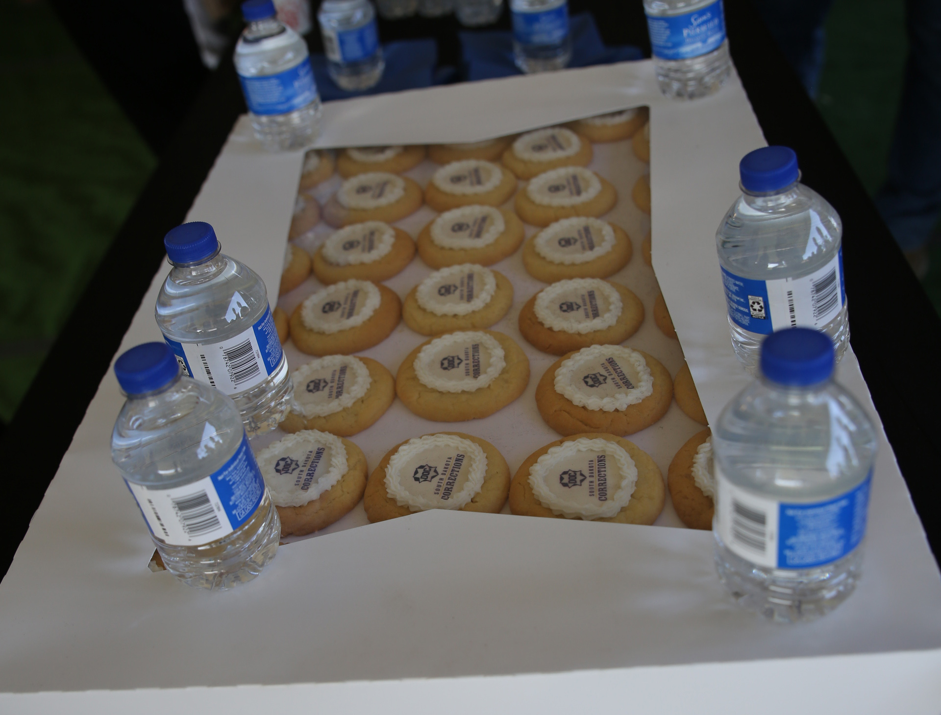 Department of Corrections cookies and bottled water, offered to attendees of the groundbreaking for a new men's prison in Sioux Falls on April 22, 2026. (John Hult/South Dakota Searchlight)