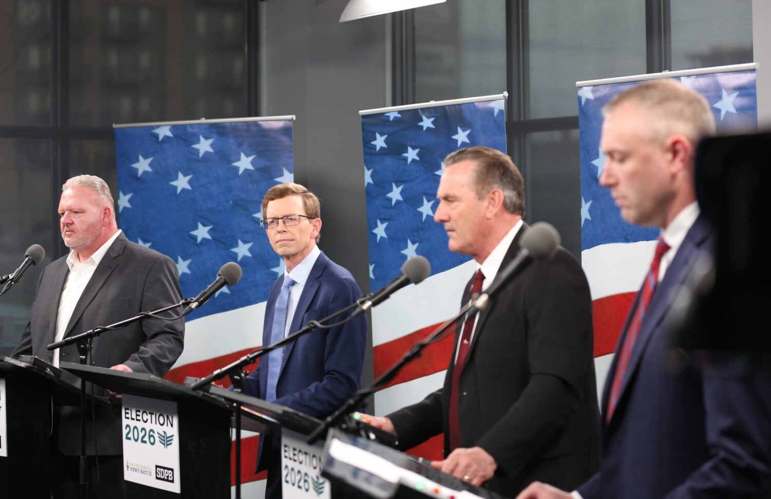 From left, Republican South Dakota gubernatorial candidates Toby Doeden, U.S. Rep. Dusty Johnson, Gov. Larry Rhoden and state House Speaker Jon Hansen participate in a debate on April 13, 2026, at the South Dakota Public Broadcasting studio in Sioux Falls. (Photo by Joshua Haiar/South Dakota Searchlight)