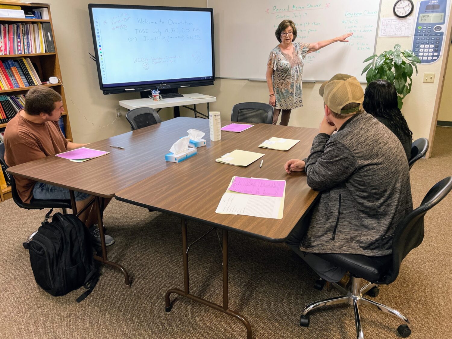 Rhonda Leneaugh conducts an orientation session on July 17, 2025, at the Career Learning Center of the Black Hills in Rapid City with, from left, Whitley Montreal, Joseph Pulaski and Kamimila Oliver. (Seth Tupper/South Dakota Searchlight)