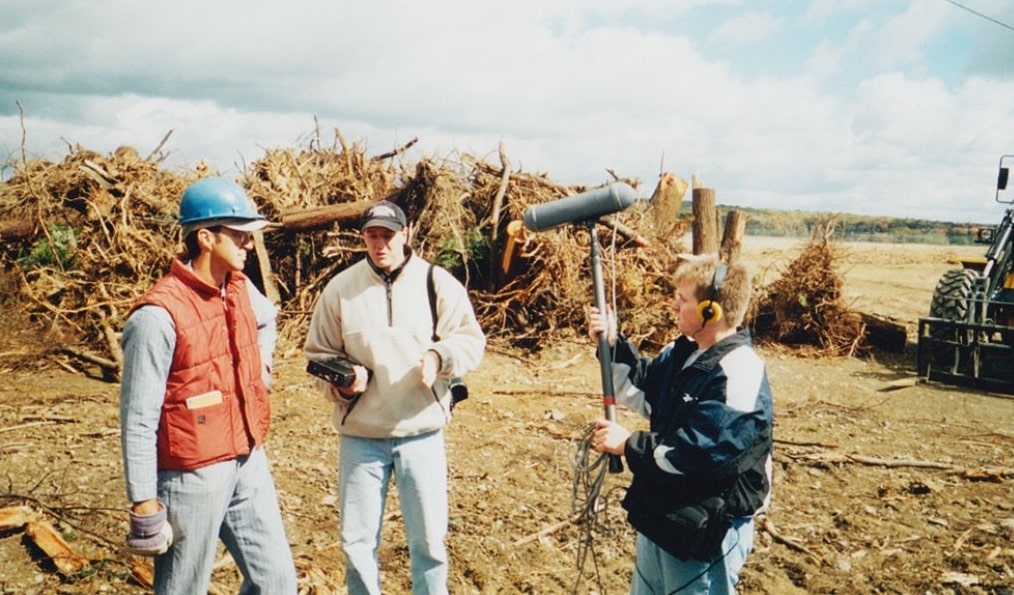 Tim Lambert, center, interviews Somerset County Coroner Wallace Miller, left. Former WITF News Director Damon Boughamer on the right records the conversation at the Flight 93 crash site on Oct. 6, 2001. (Courtesy of Tim Lambert)
