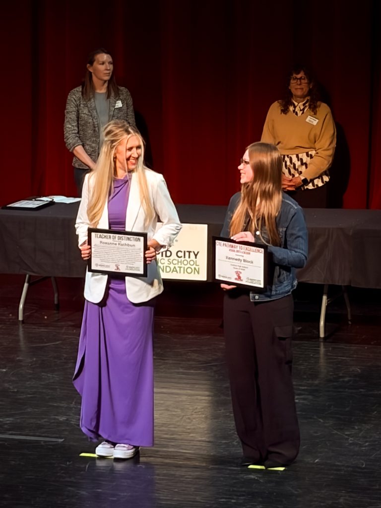 Kennedy Block and receiving _CTE_ Visual Arts & Design_ Award as Roxanne Rathbun endorses