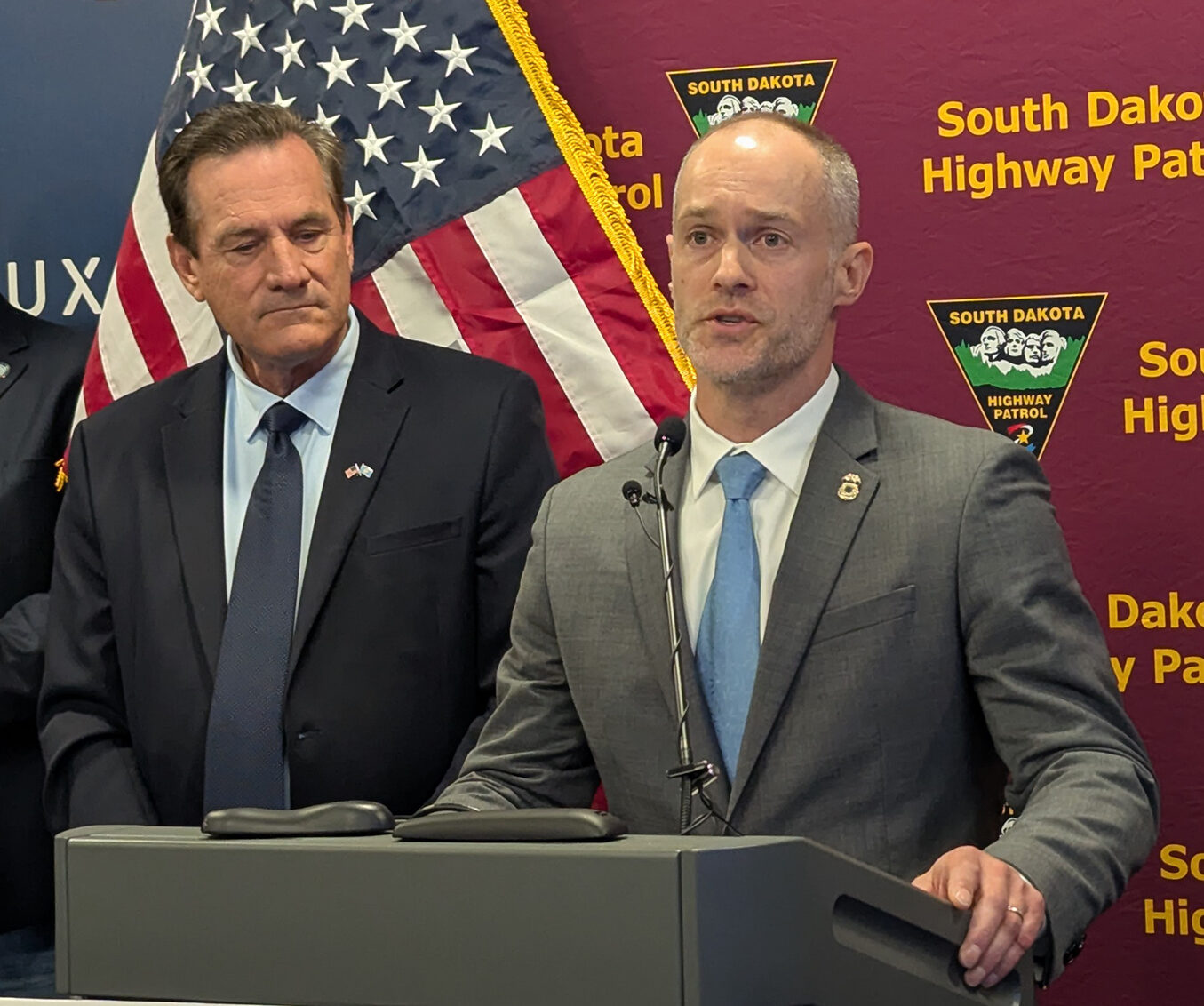 Sam Olson, Minneapolis field office director for U.S. Immigration and Customs Enforcement, speaks on July 28, 2025, at the Public Safety Administration Building in Sioux Falls. Standing near him is Gov. Larry Rhoden. (John Hult/South Dakota Searchlight)