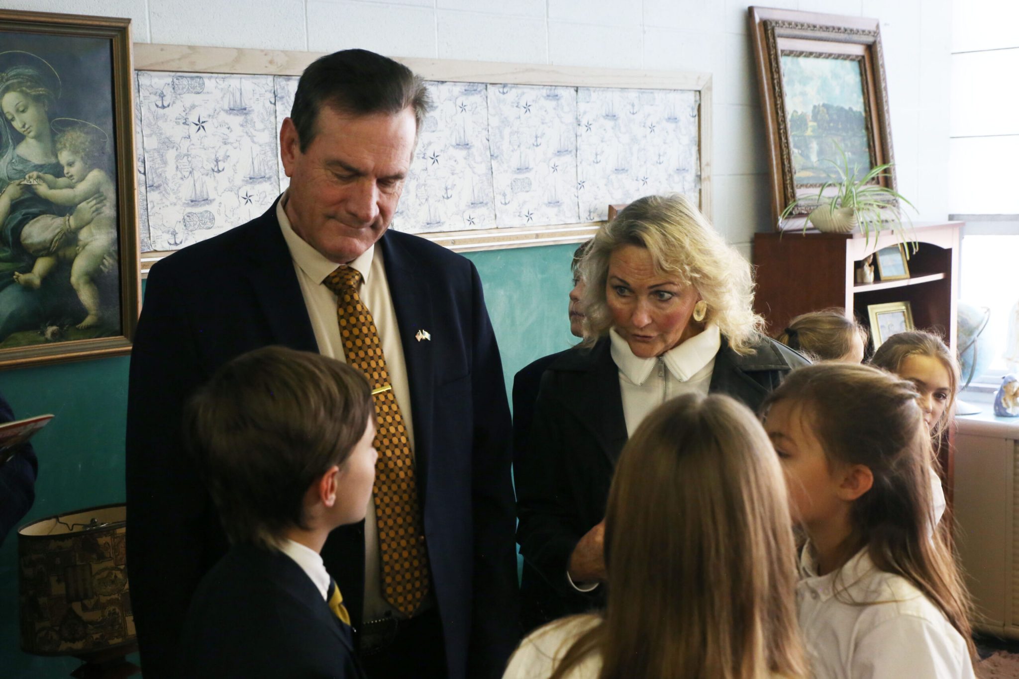 South Dakota Gov. Larry Rhoden (left) and First Lady Sandy Rhoden (right) speak to St. Joseph Academy students in Sioux Falls on Nov. 11, 2025. (Photo by Makenzie Huber/South Dakota Searchlight)