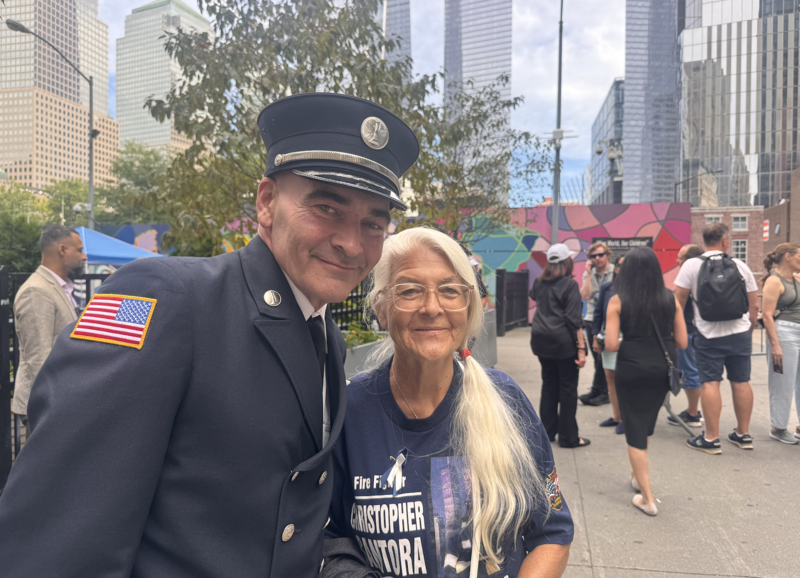 Jason Roettger, 56, and his mother, Karen Roettger, 83, attended the 25th anniversary of 9/11 in New York City on Sept. 11, 2026. He lost his cousin in the attacks on the World Trade Center and said he was honored to be chosen to read names of people who had died on that tragic day. (Photo by Shalina Chatlani/ Stateline).