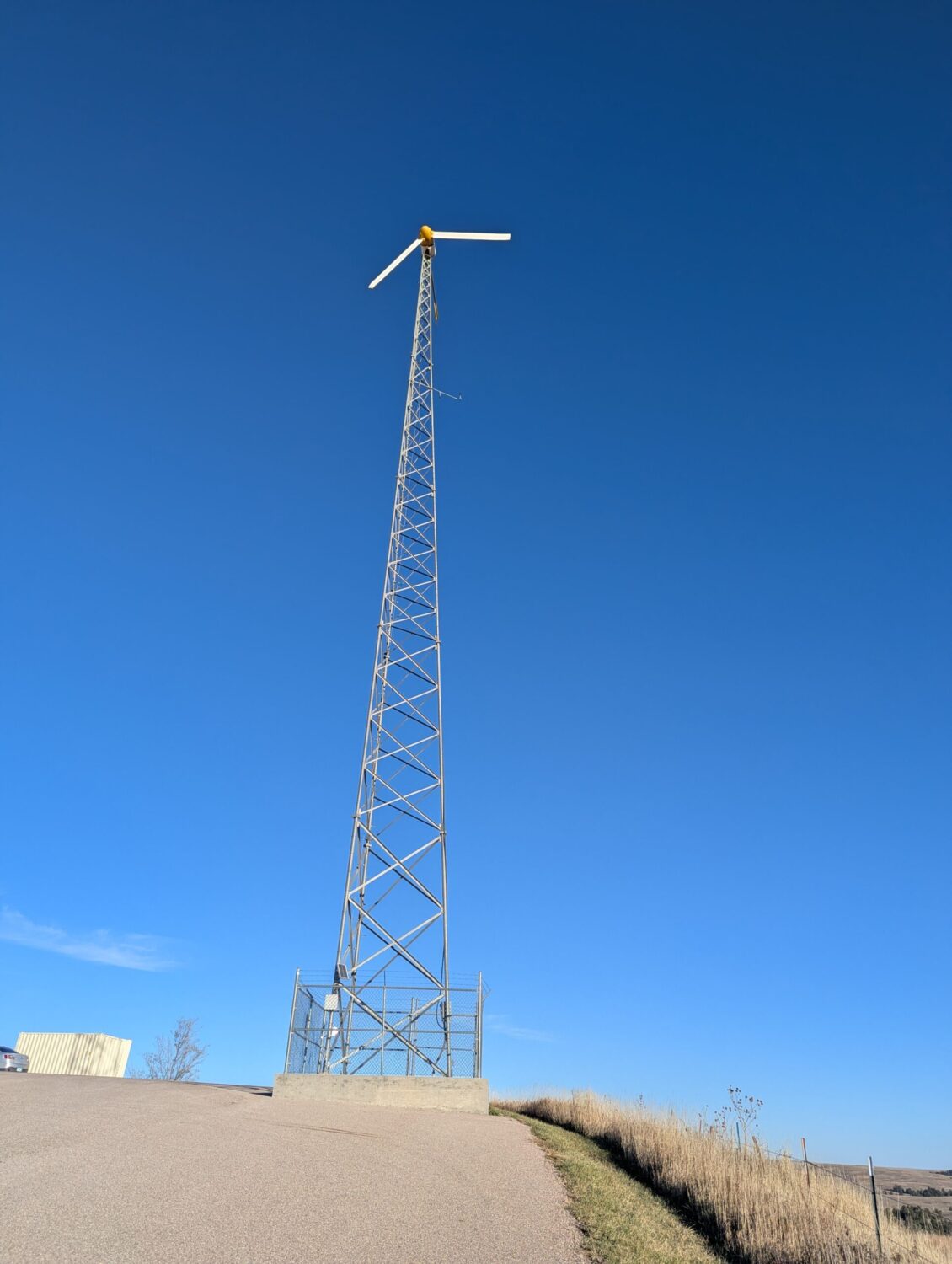 A wind turbine stands outside the KILI radio station near Porcupine, South Dakota. (Photo by John Hult/South Dakota Searchlight)
