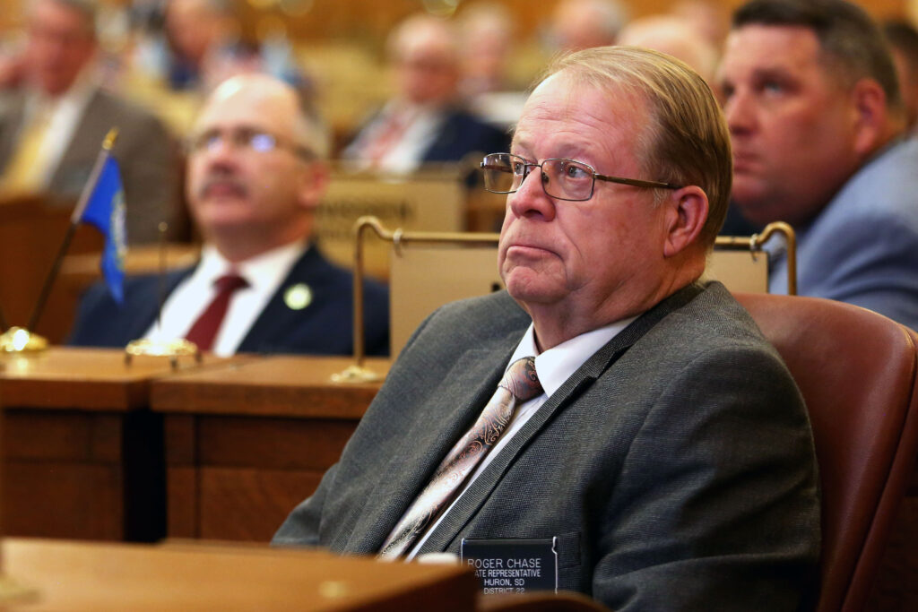 Rep. Roger Chase, R-Huron, listens to Gov. Kristi Noem during her 2023 budget address on the House floor of the South Dakota Capitol on Dec. 5, 2023. (Makenzie Huber, South Dakota Searchlight)