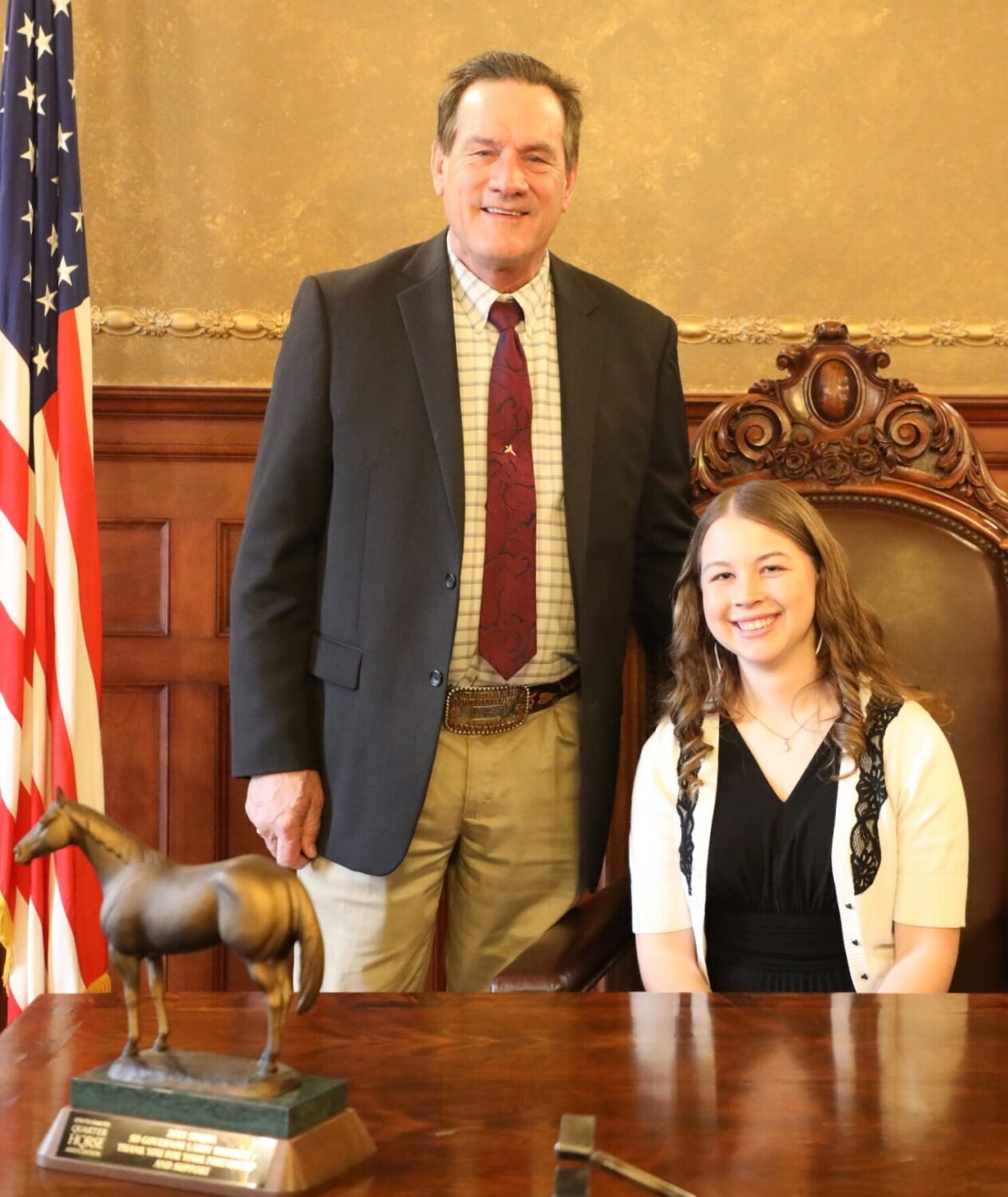 Madison Grimm joins Gov. Larry Rhoden as he signs her bill allowing federal waterfowl rescue permit holders to expand their work to other kinds of birds. (Courtesy Madison Grimm)
