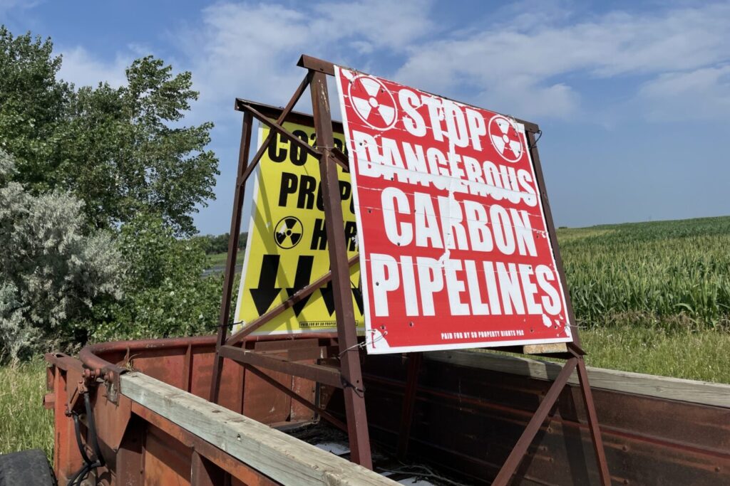 A sign opposing carbon dioxide pipelines stands alongside an eastern South Dakota farm field in July 2024. (Seth Tupper/South Dakota Searchlight)
