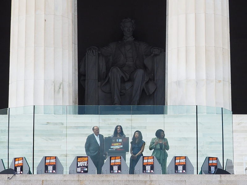 Family of the late civil rights icon Martin Luther King Jr., from left to right, son Martin Luther King III, granddaughter Yolanda Renee King and daughter-in-law Arndrea Waters King, along with a sign language interpreter, at the Lincoln Memorial in Washington, D.C., on Friday, Aug. 28, 2026, commemorating the 63rd anniversary of the March on Washington for Jobs and Freedom. (Photo by Ashley Murray/States Newsroom)