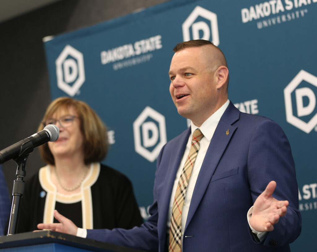Reid Rasner, who says he's pulled together a $47.45 billion bid for TikTok, speaks on May 23, 2025, at Dakota State University in Madison. At left is DSU President José-Marie Griffiths. (John Hult/South Dakota Searchlight)