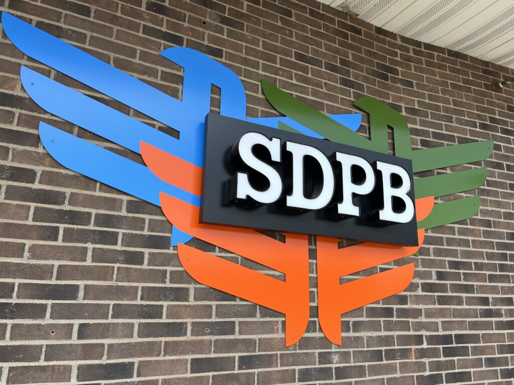 South Dakota Public Broadcasting's logo at its downtown Sioux Falls studio. (Makenzie Huber/South Dakota Searchlight)