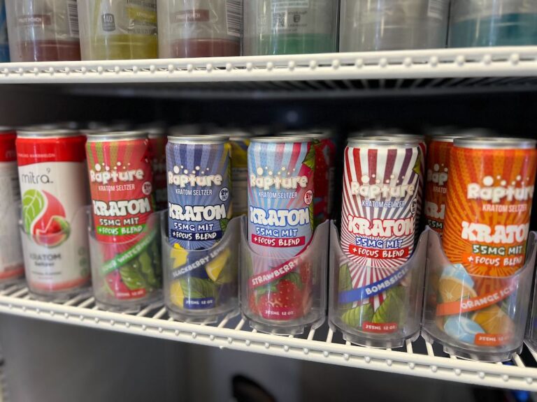 Kratom-infused drinks in a variety of flavors are displayed in a cooler at a smoke shop in Buffalo, N.Y. Some contain 55mg of mitragynine, one of the main psychoactive alkaloids in the kratom plant. (Photo by Amanda Hernández/Stateline)